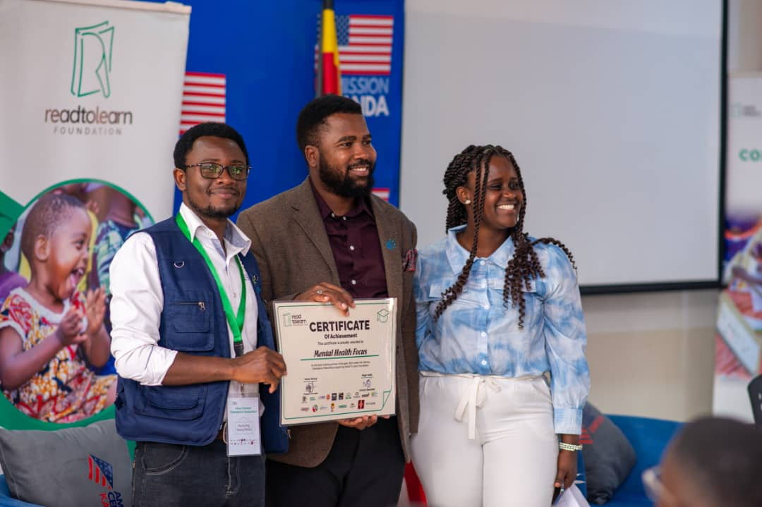 MHF Uganda representatives pose with a certificate at a Read to Learn Foundation event.
