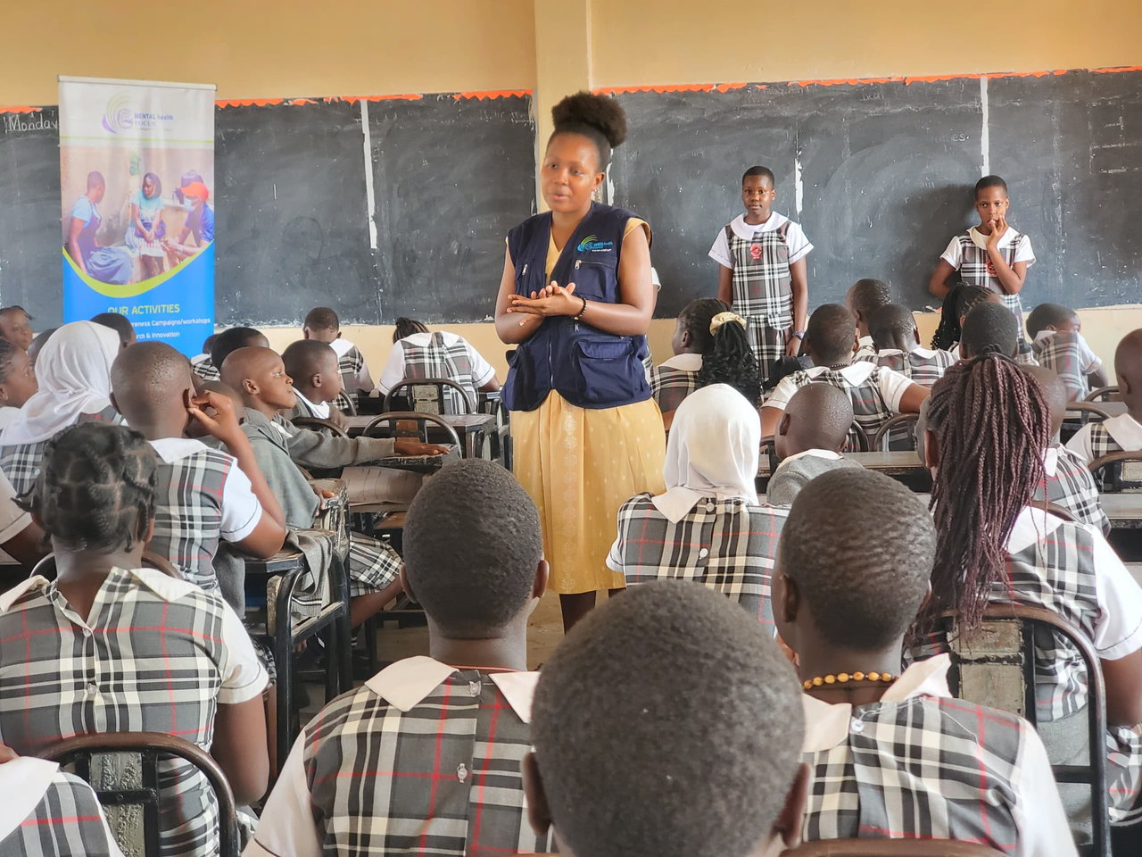 A facilitator speaks to learners during a classroom presentation.